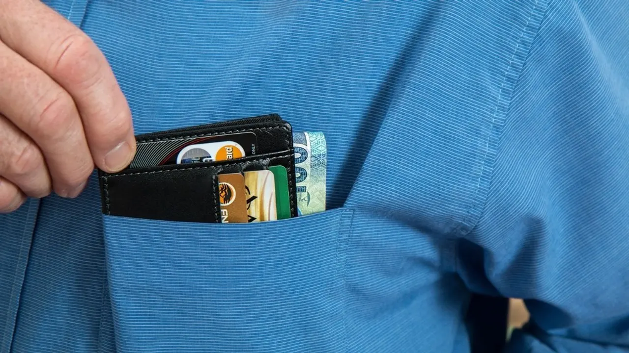Phone with a crypto wallet next to a prepaid voucher